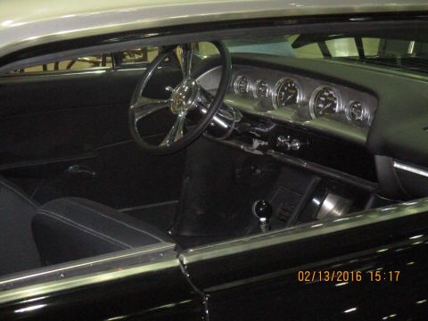 2004 Ford Crown Victoria - The interior of a classic car features a custom steering wheel and a dashboard with multiple gauges.