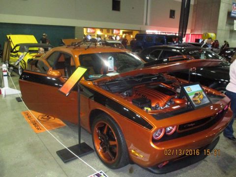 2004 Ford Crown Victoria - An orange Dodge Challenger with black racing stripes is displayed with its hood and driver's door open.