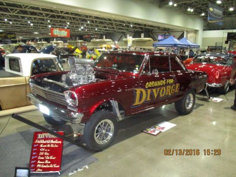 2004 Ford Crown Victoria - A highly modified 1962 Nova, nicknamed 'Grounds for Divorce', is displayed with its hood open, revealing a prominent supercharger.