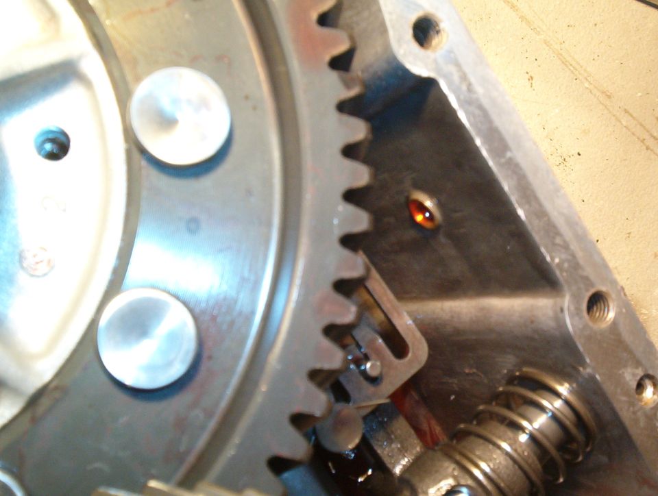 Close-up of ring gear teeth, springs and bracket inside an open aluminum transmission case