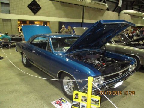 2004 Ford Crown Victoria - Blue 1967 Chevrolet Chevelle SS displayed indoors with its hood open, revealing the engine bay.