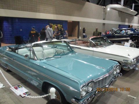 2004 Ford Crown Victoria - Two classic American convertibles are displayed indoors, with a date stamp of 02/13/2016 visible.