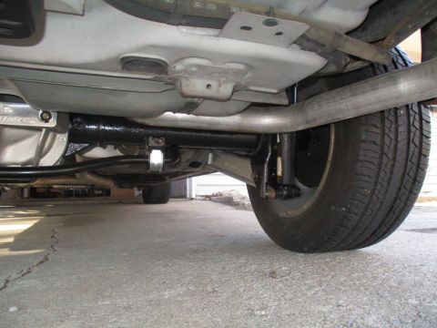 2004 Ford Crown Victoria - Undercarriage view showing the rear suspension and exhaust system of a vehicle.