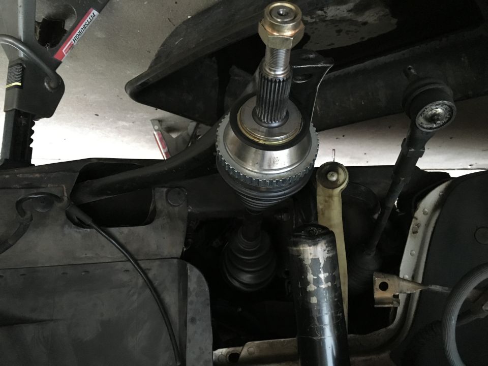 CV axle assembly and suspension parts under a vehicle, supported by a jack