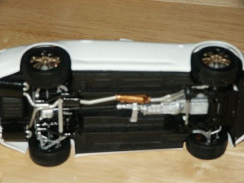1998 Mercury Sable - The underside of a white car model is displayed, revealing its exhaust system and suspension.