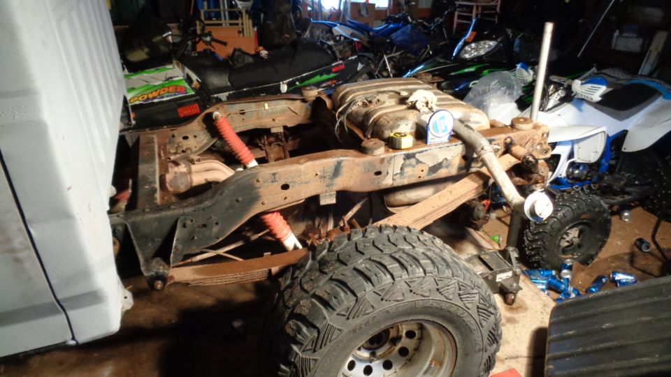 Rear suspension and frame of a vehicle with red shocks and leaf springs