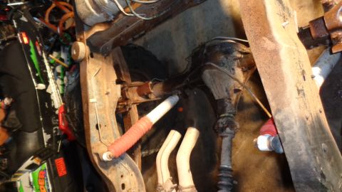 1985 Ford Bronco - Undercarriage view shows suspension components and differential, likely during maintenance.
