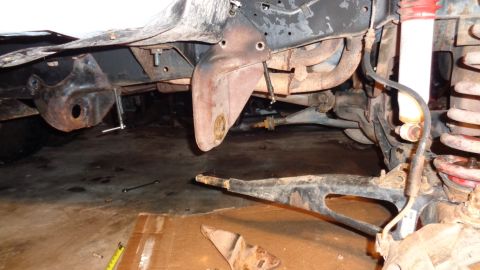 1985 Ford Bronco - Undercarriage view showing suspension components and brake lines, possibly during a repair or modification.