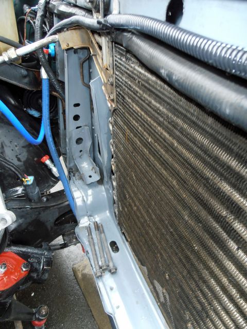 1990 Ford Bronco - Close-up view of radiator and associated engine bay components, including a blue hose.