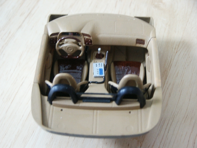 Tan toy car interior with brown seats and dashboard