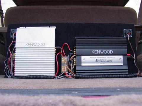 1995 Ford Bronco - Two Kenwood stereo amplifiers are installed and wired together in the cargo area of a vehicle.