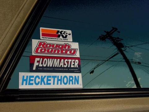 1995 Ford Bronco - Multiple aftermarket performance stickers are visible on a vehicle's window.