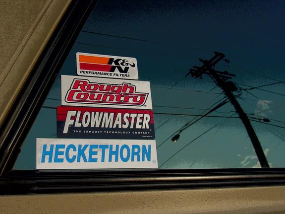Car window with K&N Performance Filters, Rough Country, Flowmaster, and Heckethorn stickers