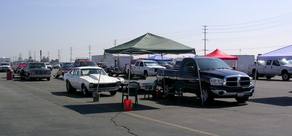 1970 Ford Maverick with racing hood scoop parked at an outdoor event