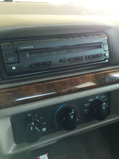 1996 Ford Bronco - The dashboard features a Kenwood stereo and climate controls, with faux wood trim accents.