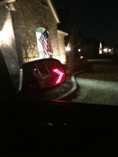 1996 Ford Bronco - The side mirror displays a red arrow turn signal, indicating a vehicle is present.