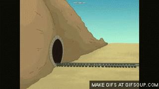 1995 Mercury Grand Marquis - A train emerges from a tunnel in a desert landscape.
