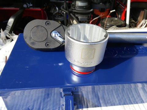 2000 Ford Crown Victoria - A close-up shot of a large socket wrench and a socket with the number '2' embossed on it, resting on a blue toolbox. The tools appear to be…