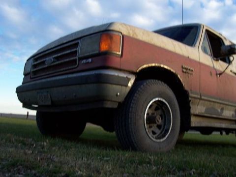 1987 Ford Bronco - This truck has a two-tone paint job and a grille that suggests a model year in the late 1980s.