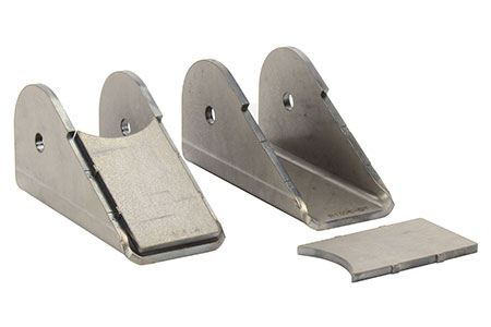 1981 Ford Bronco - Two steel fabrication tabs with holes are shown, along with a separate curved steel piece. The tabs are angled and appear to be designed fo…