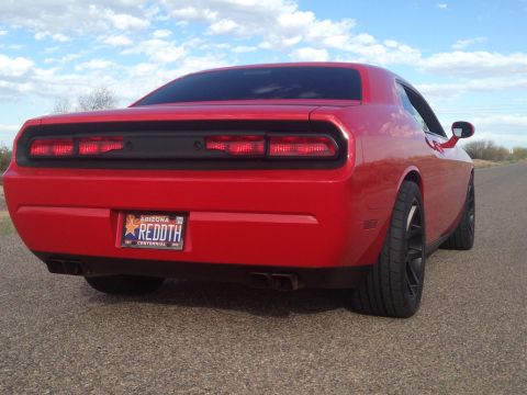 2010 Dodge Challenger - Rear view of a red 2010 Dodge Challenger with aftermarket wheels and a custom Arizona license plate.