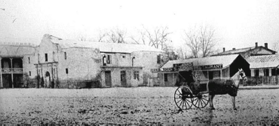 Horse-drawn carriage in front of old buildings, one labeled 'RESTAURANT'