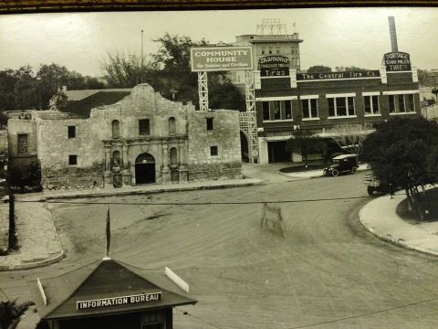 1909 Ford Model T - A street scene shows the historic Alamo building alongside commercial establishments and vehicles.