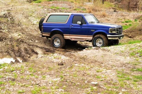 1996 Ford Bronco - This 1996 Ford Bronco navigates a challenging muddy terrain.