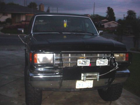 1988 Ford Bronco - Front view of a black 1988 Ford Bronco equipped with a winch and auxiliary lights.