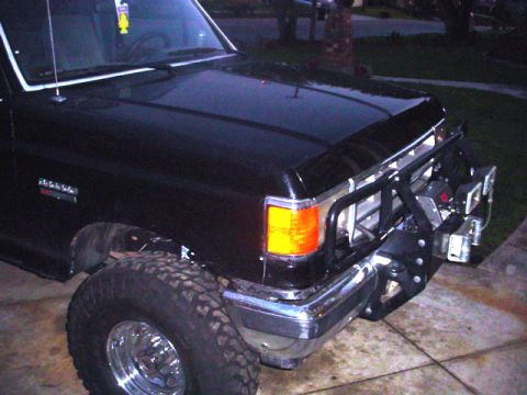 1988 Ford Bronco - Front view of a black 1988 Ford Bronco equipped with a bull bar and off-road tires.