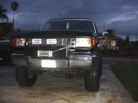 1988 Ford Bronco - This lifted truck has a custom bumper with a winch and auxiliary lights mounted on the front.