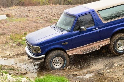 1996 Ford Bronco - This 1996 Ford Bronco is shown off-roading through a muddy terrain.