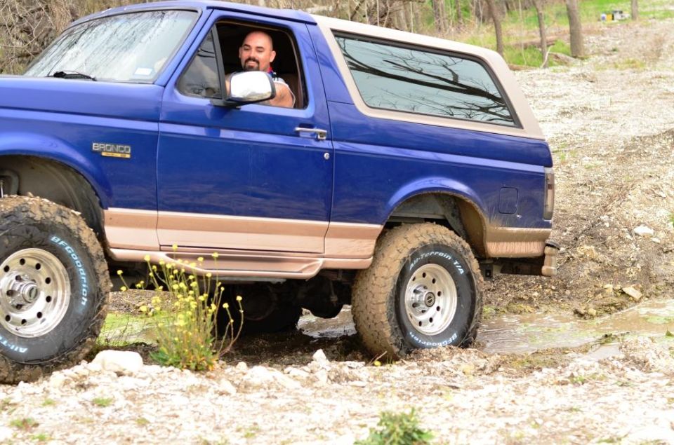 1996 Ford Bronco 3q-front view, blue with tan trim, off-roading