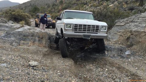 1979 Ford Bronco - This lifted 1979 Ford Bronco is shown off-roading on a rocky trail with another Jeep in the background.