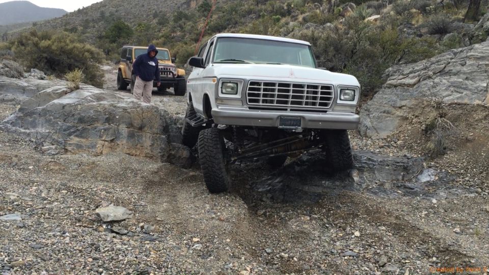 White 1979 Ford Bronco navigating rocky terrain