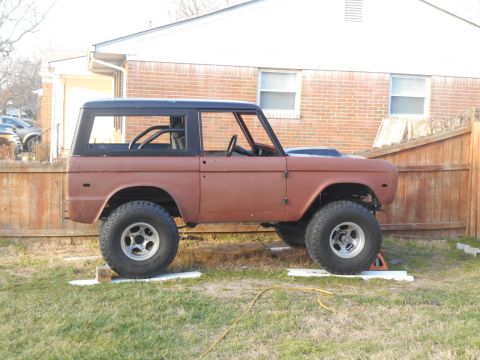 1972 Ford Bronco - Ford Bronco body undergoing restoration, a roll cage and aftermarket hood scoop.