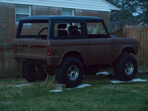 1972 Ford Bronco - This 1972 Ford Bronco appears to be undergoing restoration, with its brown body and black hardtop visible.