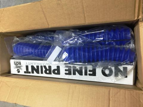 1996 Ford Bronco - New blue shock dust boots are packaged in a cardboard box with warranty information.