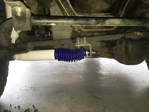 1996 Ford Bronco - Close-up of a vehicle's rear axle and suspension components, focusing on a shock absorber.