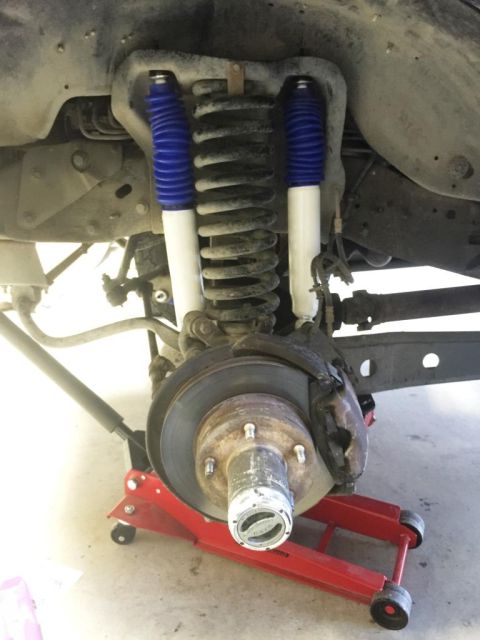 1996 Ford Bronco - Close-up of a vehicle's front suspension system, new shocks and brake components.