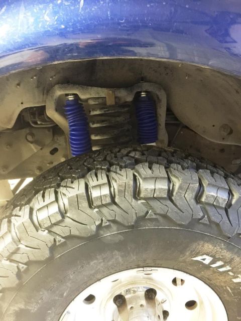 1996 Ford Bronco - Rear suspension shocks and tire are visible in this close-up view.