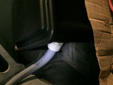 1981 Ford LTD - Joining the flexible conduit to the battery box. I used a special bulkhead fitting. Should be nice and airtight once it's all said and done.