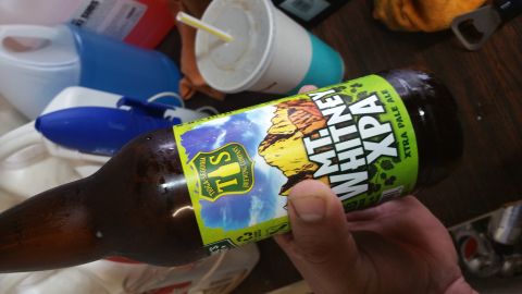 1995 Ford Mustang - A hand holds a bottle of Whitney XPA beer. The label features a mountain landscape and the Tioga-Sequoia Brewing Company logo. Other items…