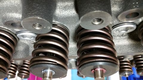 1995 Ford Mustang - A close-up view of valve springs and related components on what appears to be an engine cylinder head. Several metallic springs are visible…