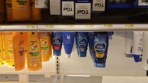 1995 Ford Mustang - A shelf in a store displays various bottles of shampoo and conditioner, including Garnier Fructis and Selsun Blue products. The bottles are…
