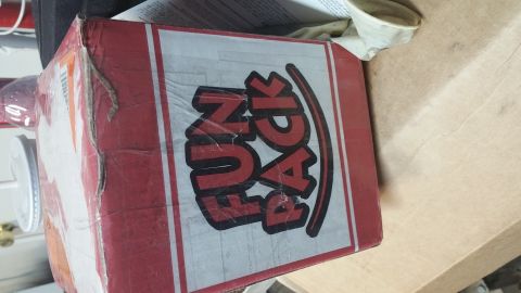 1995 Ford Mustang - A red and white cardboard box with "FUN PACK" printed on the side is shown in a cluttered setting.
