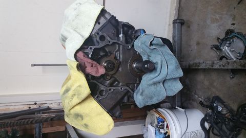 1995 Ford Mustang - A disassembled engine block is covered with several microfiber towels in a garage setting. The front of the engine block is exposed, showin…