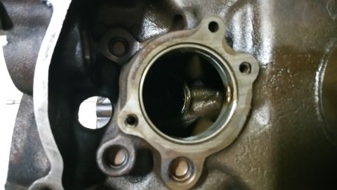 1995 Ford Mustang - Close-up view of the internal components of a cast iron engine block, likely a V8, showing a circular opening with mounting bolts and inter…