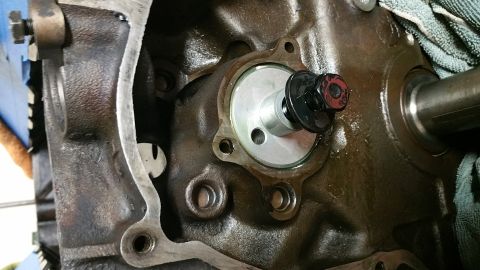 1995 Ford Mustang - A close-up view shows a water pump housing installed on a dark-colored engine block. The housing is secured with bolts and a gasket is visi…