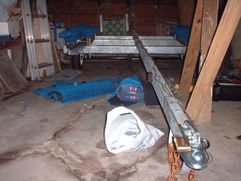1996 Ford Taurus - A trailer is parked indoors with various items scattered around it.